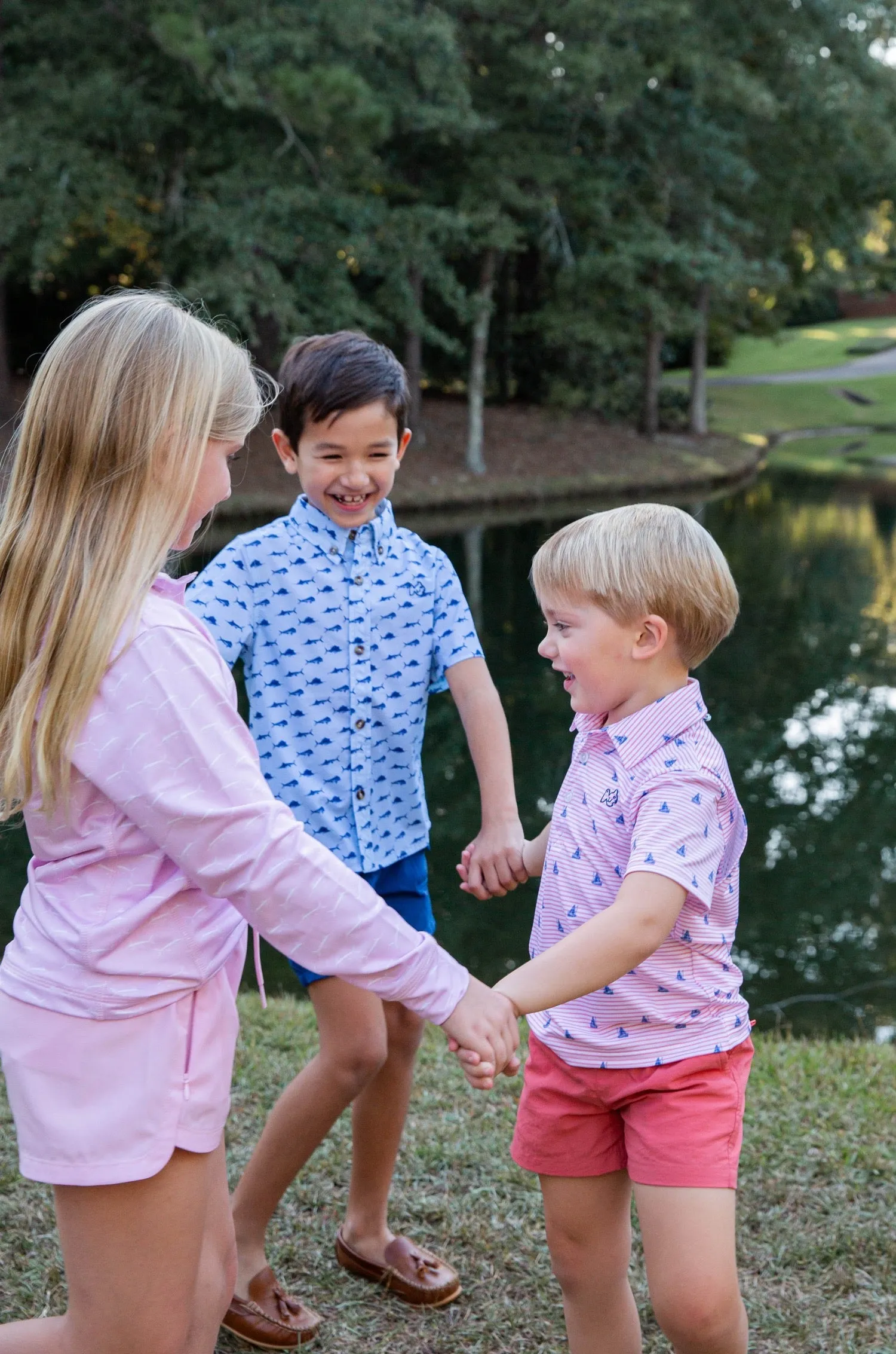 Boys Short Sleeve Pro Performance Polo in Fishing Boat Print on Spiced Coral Stripe