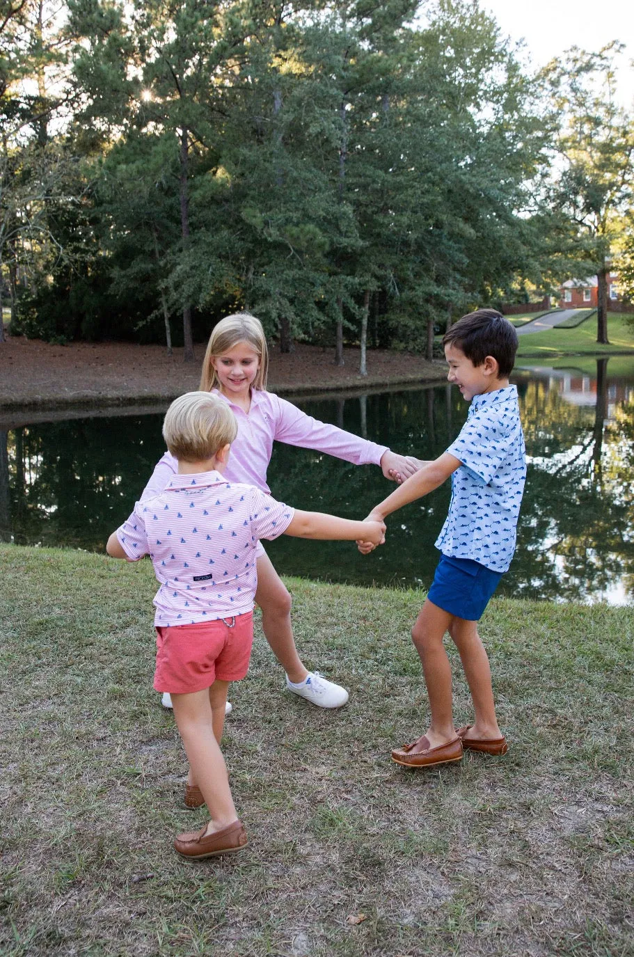 Boys Short Sleeve Pro Performance Polo in Fishing Boat Print on Spiced Coral Stripe
